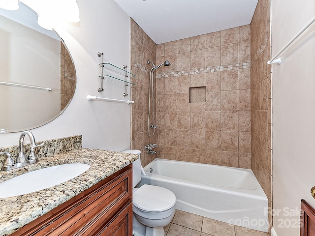 full bathroom featuring toilet, vanity, tile patterned floors, and tiled shower / bath