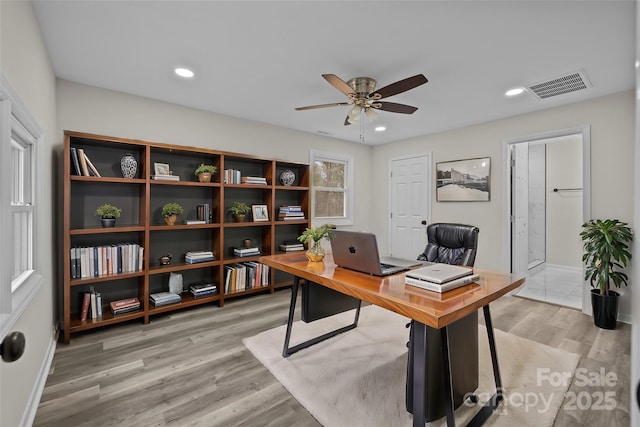 office space with ceiling fan and light hardwood / wood-style floors