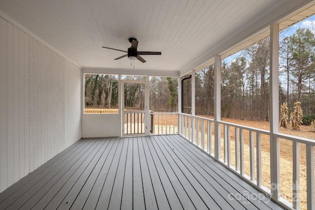 unfurnished sunroom featuring ceiling fan