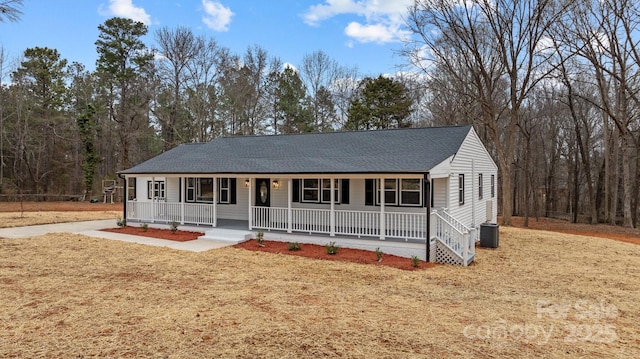 view of front of property with a front lawn, cooling unit, and a porch