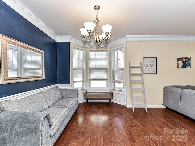 living area with a chandelier, dark hardwood / wood-style flooring, and crown molding