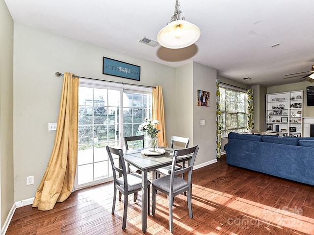 dining area featuring a healthy amount of sunlight, ceiling fan, and dark wood-type flooring