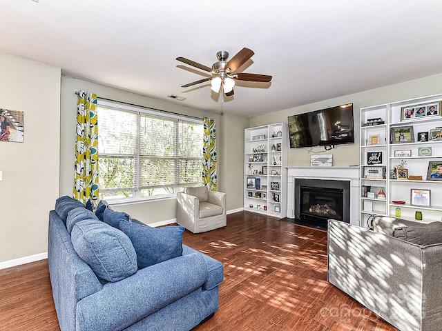 living room with ceiling fan and dark hardwood / wood-style flooring