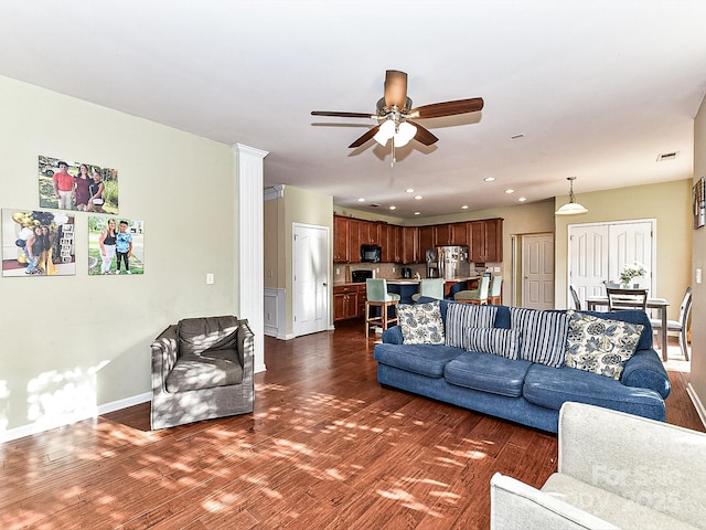 living room featuring dark hardwood / wood-style floors and ceiling fan