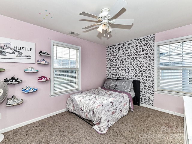 bedroom featuring multiple windows, ceiling fan, and carpet