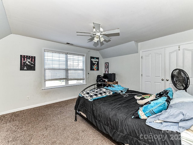 bedroom featuring carpet flooring, ceiling fan, a closet, and vaulted ceiling