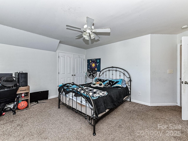 carpeted bedroom featuring ceiling fan and a closet