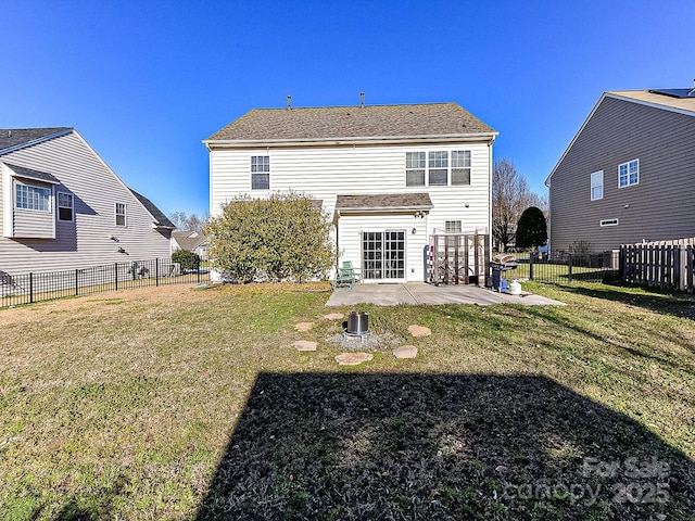 rear view of property with a yard and a patio