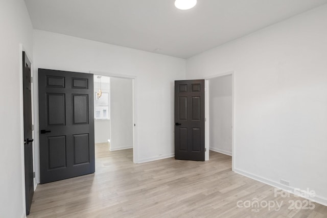 unfurnished room with light hardwood / wood-style flooring