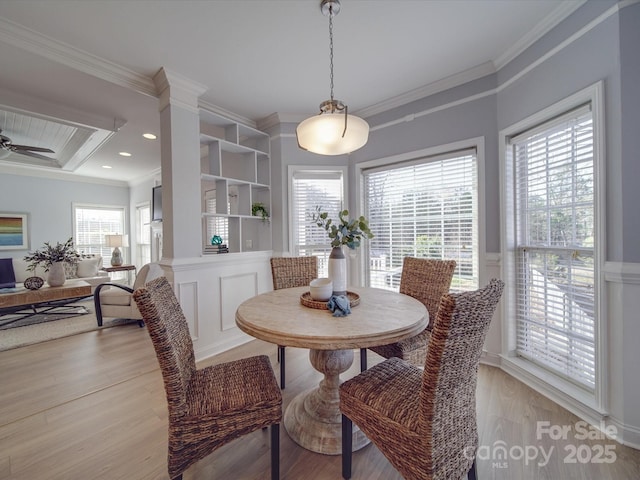 dining area with ceiling fan, light wood-type flooring, and ornamental molding