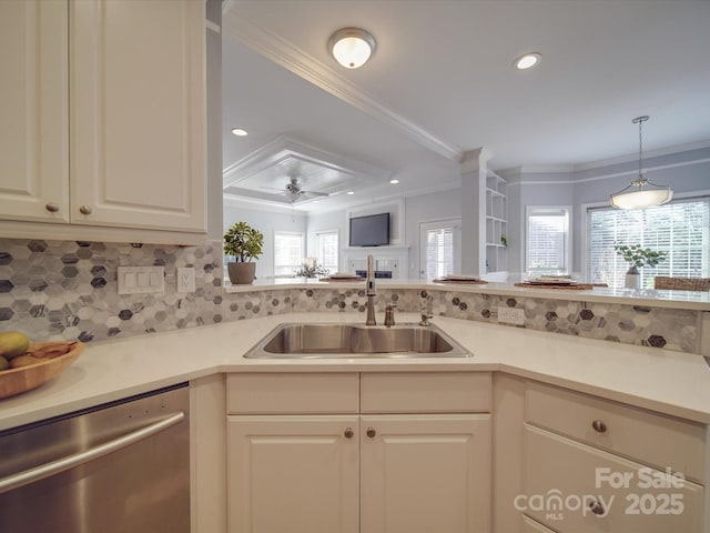 kitchen featuring tasteful backsplash, ceiling fan, crown molding, sink, and dishwasher