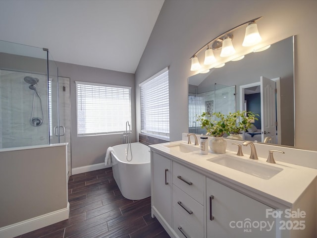 bathroom featuring vanity, shower with separate bathtub, and vaulted ceiling