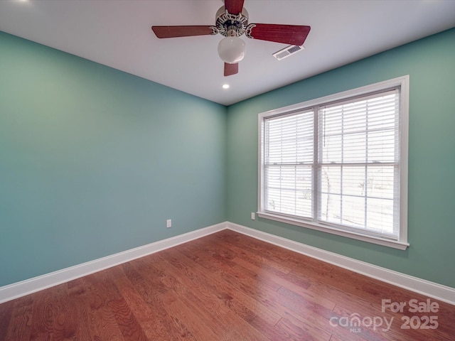 empty room featuring ceiling fan and wood-type flooring