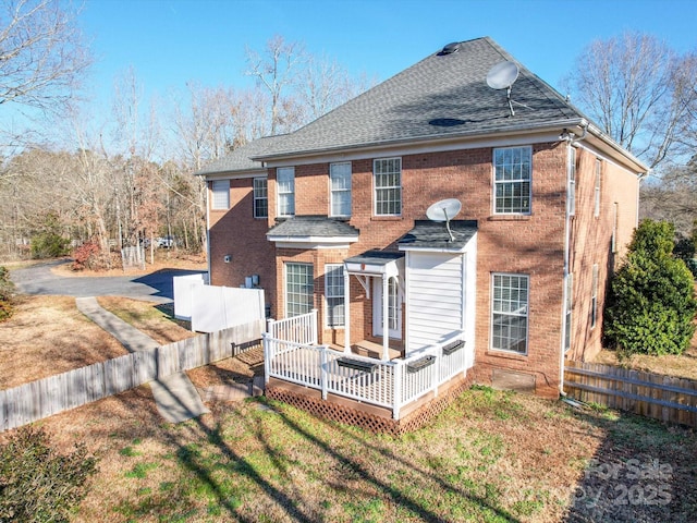 rear view of property featuring a deck