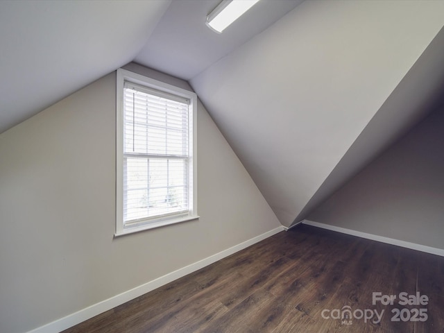 bonus room featuring dark hardwood / wood-style flooring and vaulted ceiling