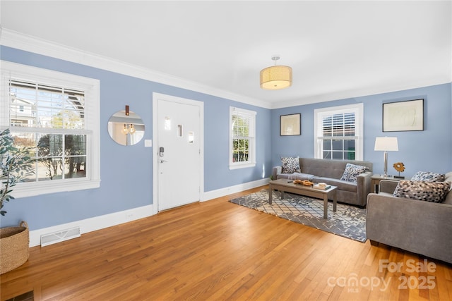 living room with hardwood / wood-style floors and ornamental molding