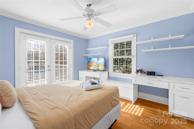 bedroom featuring ceiling fan, access to exterior, built in desk, french doors, and light wood-type flooring