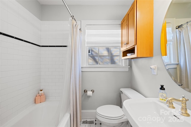 full bathroom featuring toilet, shower / bathtub combination with curtain, and sink