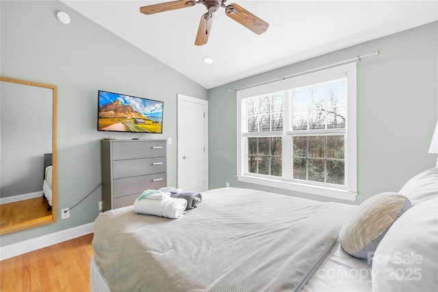 bedroom with vaulted ceiling, ceiling fan, and light hardwood / wood-style flooring