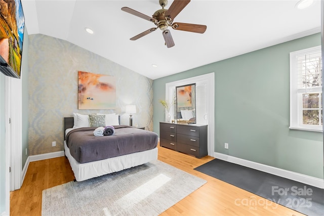 bedroom with hardwood / wood-style flooring, ceiling fan, and vaulted ceiling