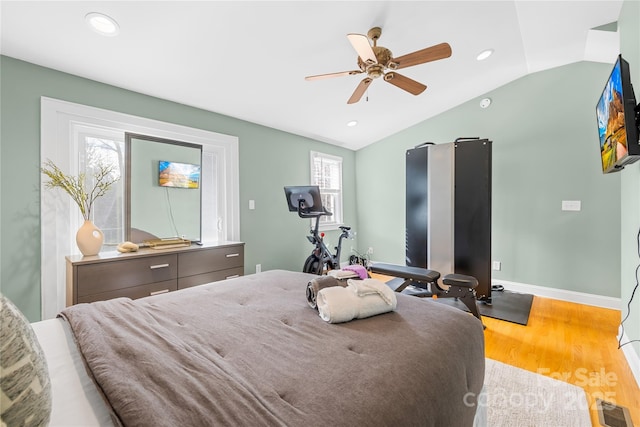 bedroom with ceiling fan, lofted ceiling, and hardwood / wood-style floors