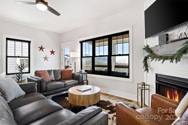 living room with ceiling fan and wood-type flooring