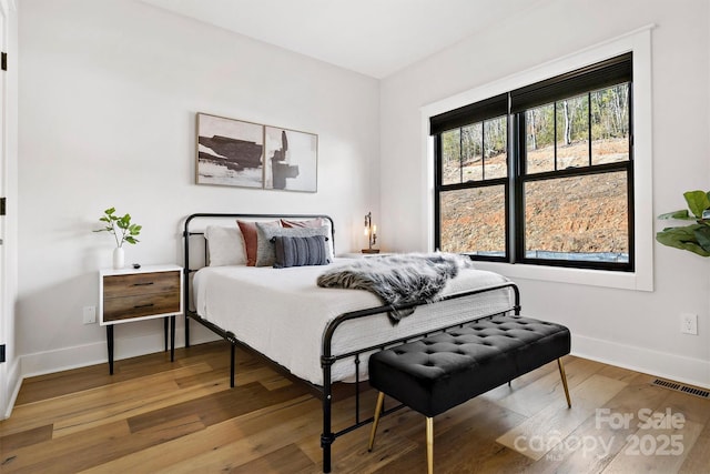 bedroom with hardwood / wood-style floors