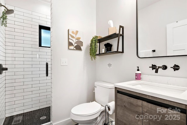 bathroom featuring vanity, toilet, and a shower with shower door