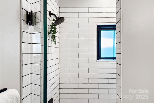 bathroom with tiled shower