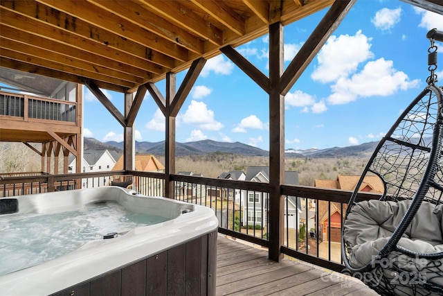 wooden terrace featuring a mountain view and a hot tub