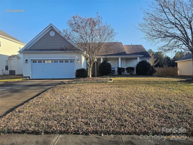 ranch-style home featuring cooling unit, a front yard, and a garage