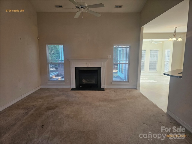 unfurnished living room featuring ceiling fan and light carpet