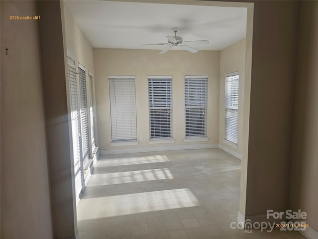 interior space with ceiling fan