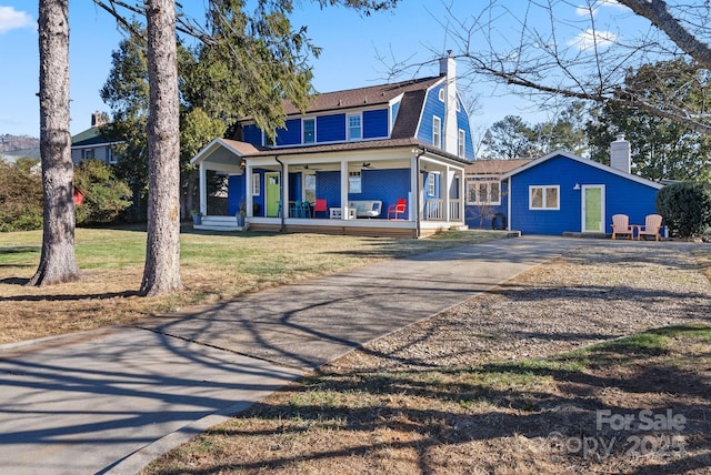 view of property featuring a front lawn and a porch