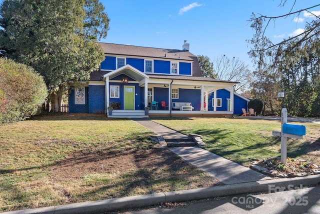 view of front of house with covered porch and a front yard