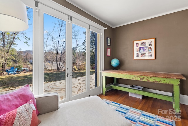 bedroom featuring access to exterior, hardwood / wood-style flooring, and ornamental molding