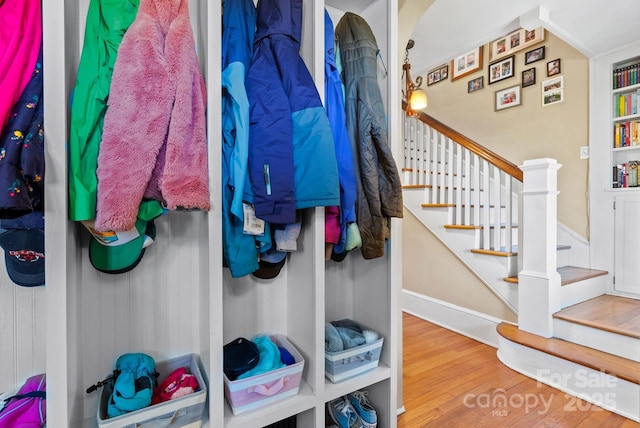 mudroom featuring hardwood / wood-style flooring and built in features