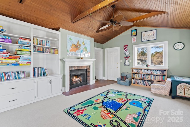 game room with ceiling fan, carpet floors, wood ceiling, and a brick fireplace