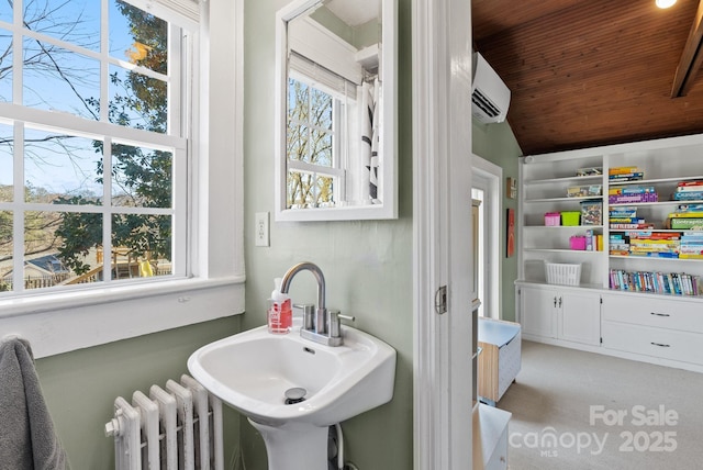 bathroom with lofted ceiling, radiator, sink, wood ceiling, and a wall unit AC