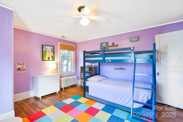 bedroom featuring radiator heating unit, dark hardwood / wood-style floors, ceiling fan, and ornamental molding