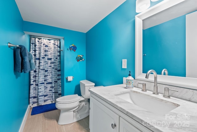 bathroom featuring a shower with curtain, vanity, and toilet