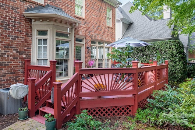 wooden terrace featuring central air condition unit