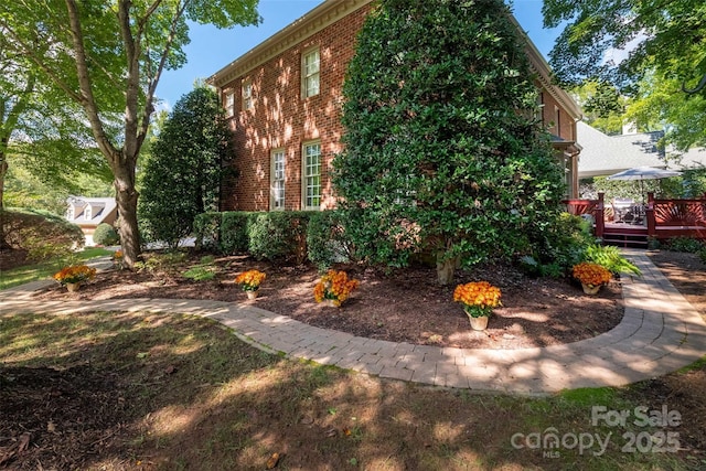 view of property exterior with a wooden deck