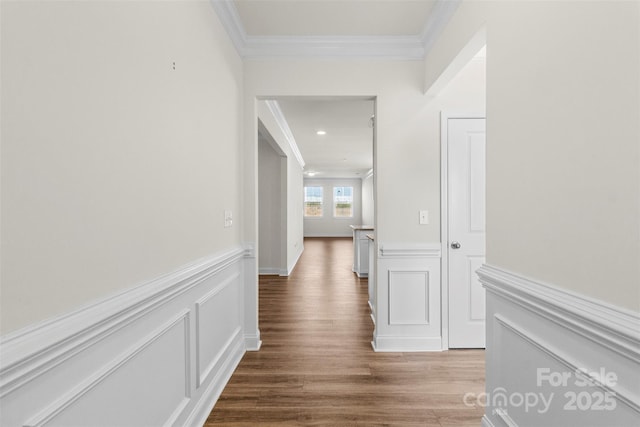 corridor featuring wood-type flooring and ornamental molding