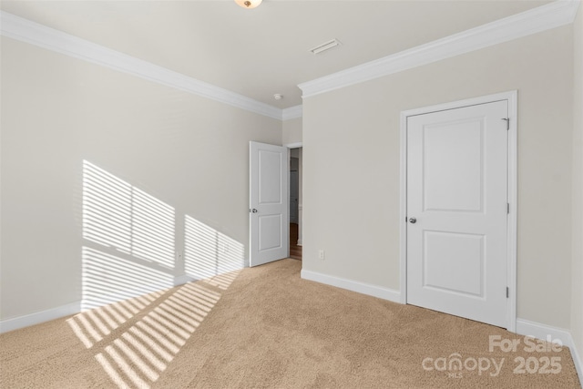 unfurnished bedroom with light colored carpet and crown molding