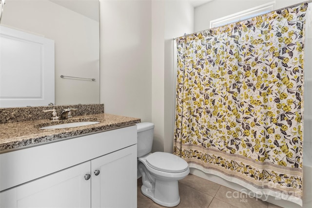 bathroom featuring tile patterned flooring, vanity, and toilet