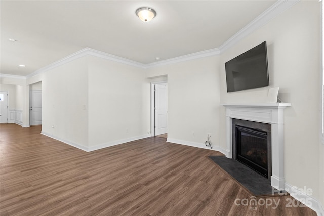 unfurnished living room featuring dark wood-type flooring and crown molding