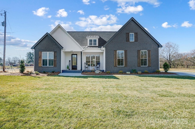 rear view of property featuring a lawn