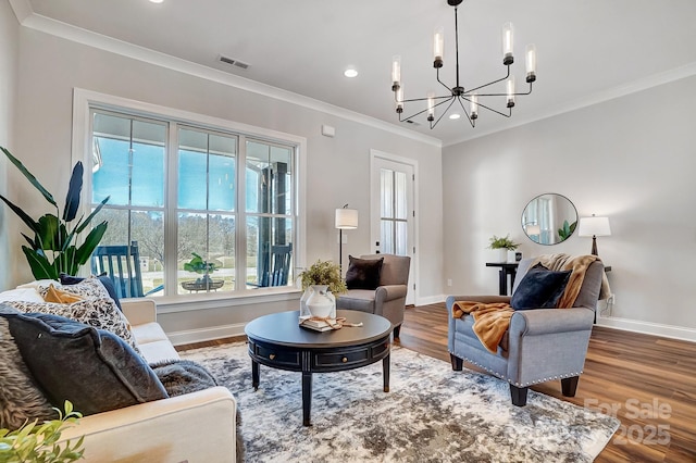 living room with crown molding, a chandelier, and hardwood / wood-style flooring