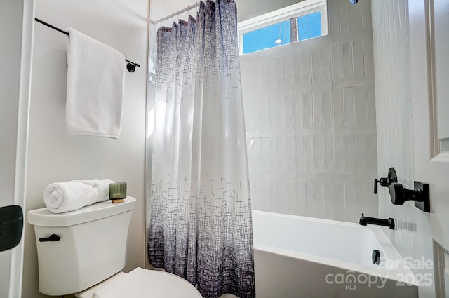 bathroom featuring shower / bath combination with curtain and toilet